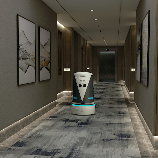 A Richie hotel delivery robot traveling down a hotel hallway.